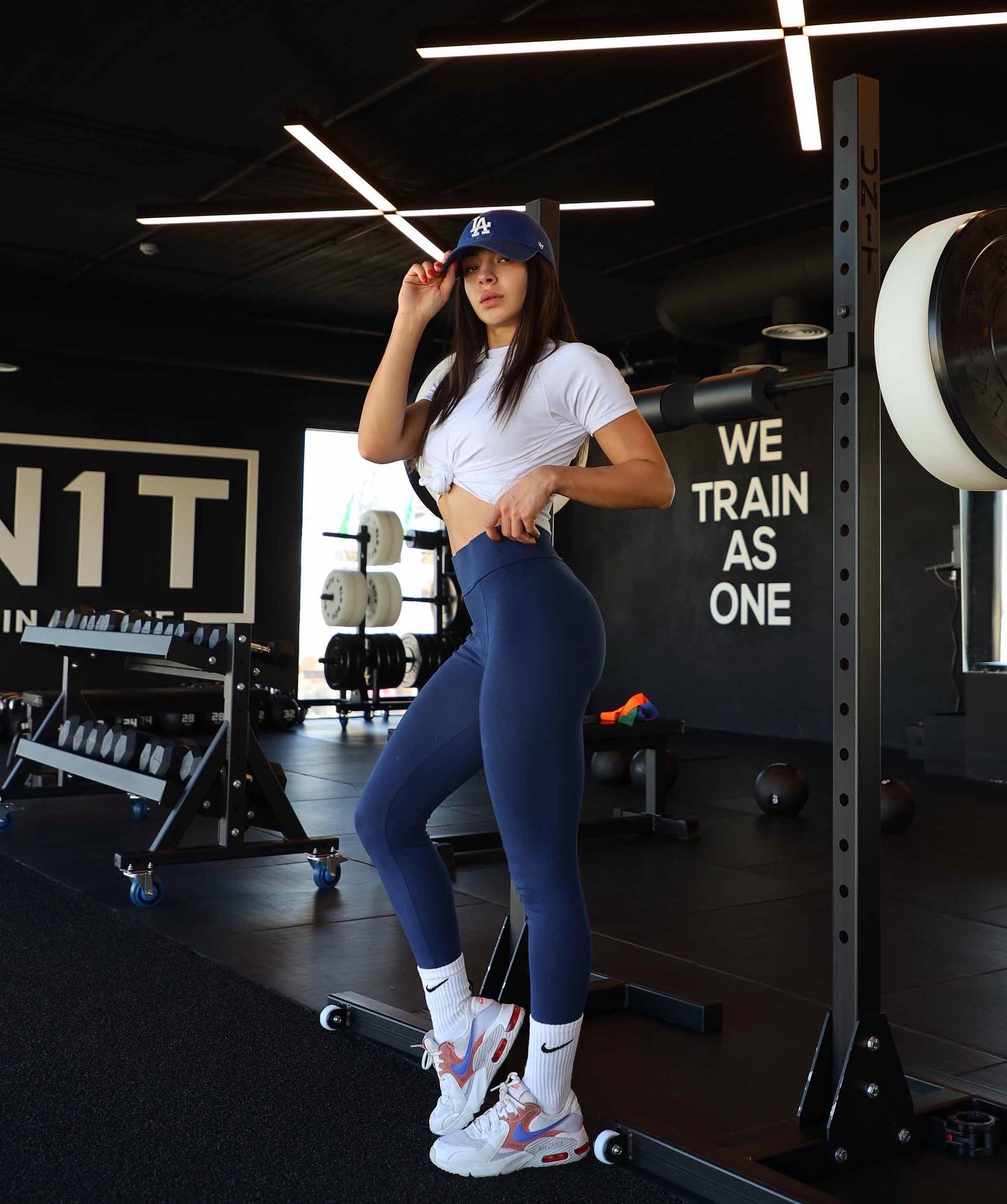 Maya standing beside gym equipment